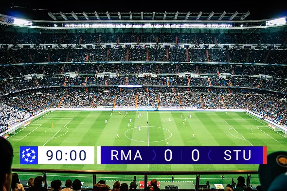 Soccer field with a ball under stadium lights